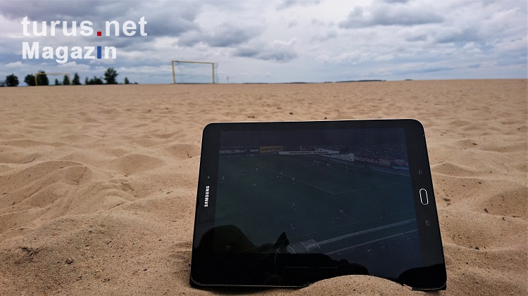 Fußball gucken auf dem Tablet am Strand