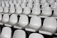 Leere Sitzschalen in einem Fußballstadion, noch sind die Sitze frei...