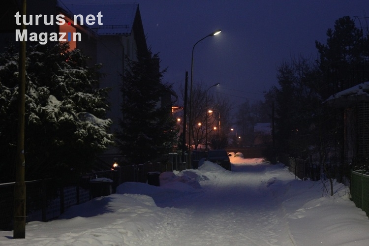 verschneite Straße in einer Siedlung