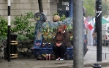 Typisch irisches Wetter in Sligo. Egal, eine Frau sitzt auf der Bank und trinkt Bier ...